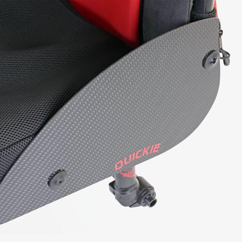 A carbon sideguard on the side of a manual wheelchair.
