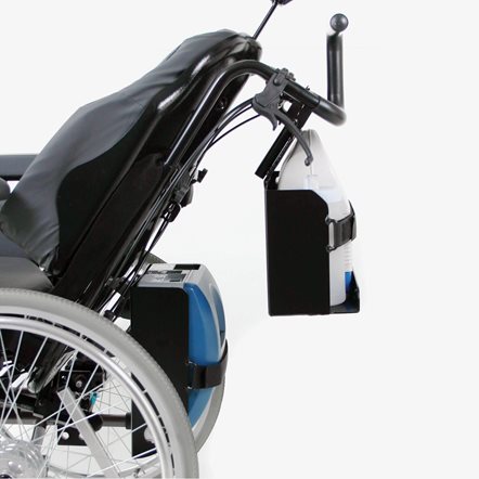 A mounted medical device on the backrest of a manual wheelchair.