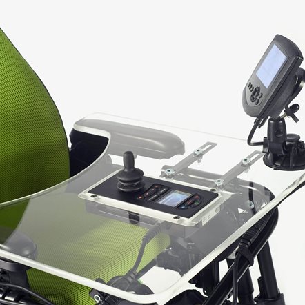 Close up of a transparent tray table, with a controller mounted centrally onto the tray table.