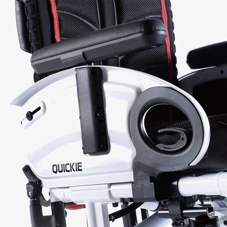 A desk armrest on a wheelchair.