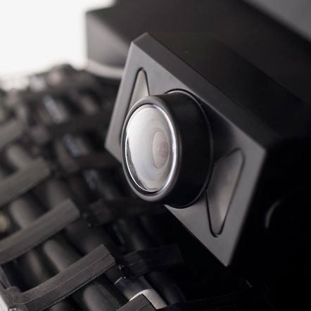 Close up of a reversing camera mounted onto a power wheelchair.