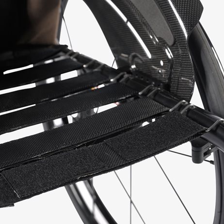 A wheelchair with a seat sling clip.
