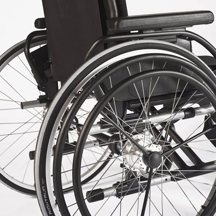 A one arm drive mounted onto the wheel of a manual wheelchair.