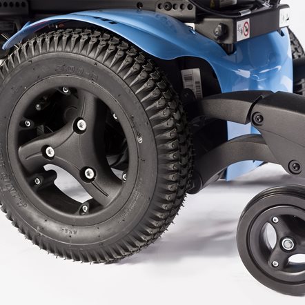 Close-up of a blue shroud on a mid wheel drive powered wheelchair.