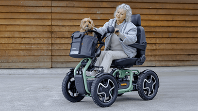 A woman stationary in a 4 wheel mobility scooter.